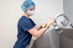 University of Findlay student washing arms in lab