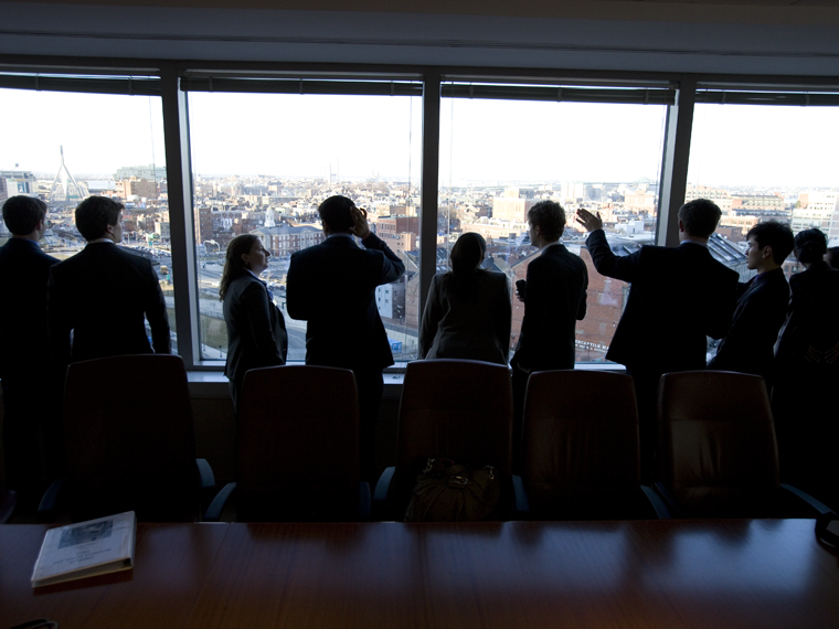 A group of business people looking out a window