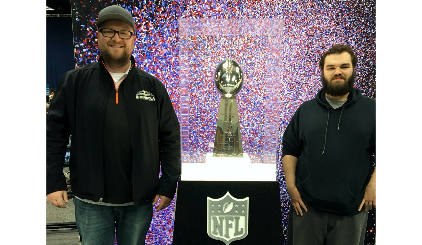 Nick Wiget (LEFT) and Mark Jarvis pose with the Lombardi Trophy, which is awarded to the Super Bowl winner.